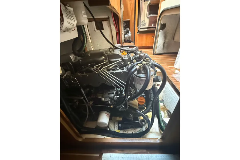 Slide: The Image of Engine compartment of a 2007 Hunter 41 Deck Salon sailboat, showcasing mechanical components. - 33