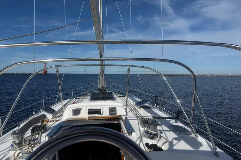 Slide: The Image of 2007 Hunter 41 Deck Salon sailboat on open water under clear blue skies. - 7