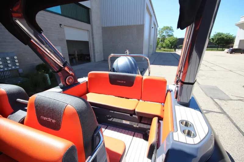 Slide: The Image of 2021 Zodiac Medline 7.5 boat interior with orange seating and modern design. - 10