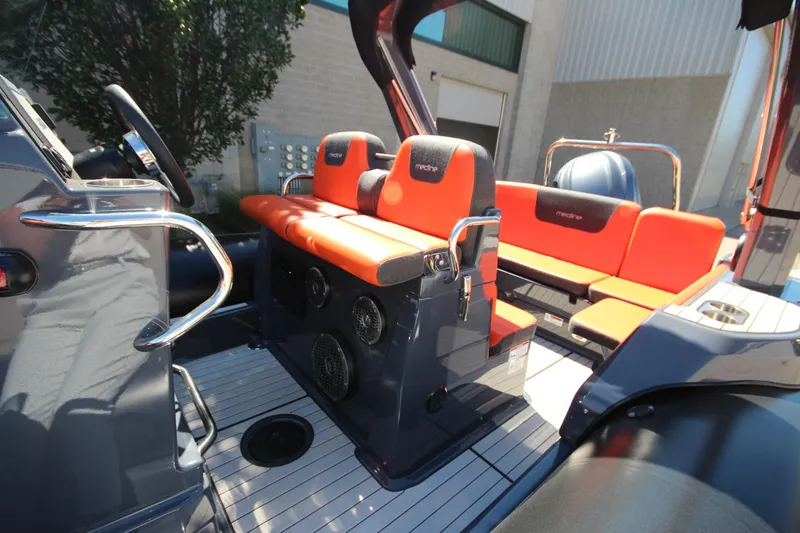 Slide: The Image of 2021 Zodiac Medline 7.5 boat interior with orange seating and modern design. - 15