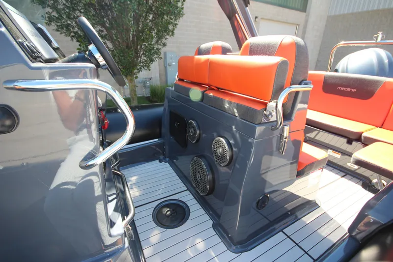 Slide: The Image of 2021 Zodiac Medline 7.5 boat interior with orange seating and modern dashboard. - 16