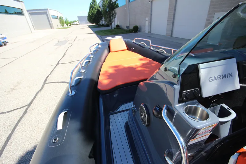 Slide: The Image of 2021 Zodiac Medline 7.5 boat with orange seating and Garmin navigation system. - 19