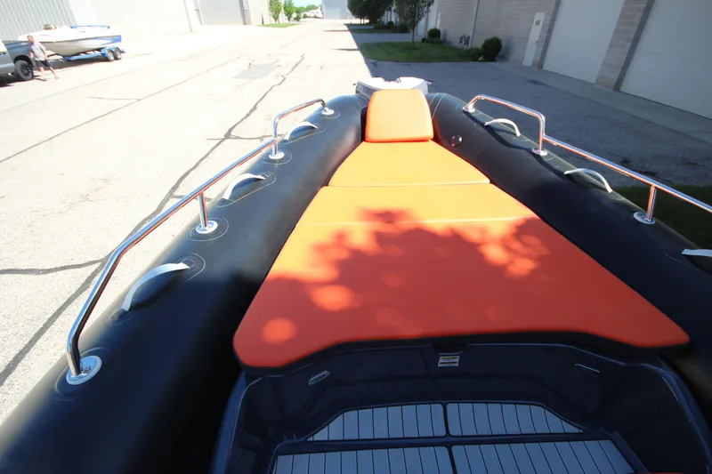 Slide: The Image of 2021 Zodiac Medline 7.5 boat with orange seating, docked outdoors. - 23
