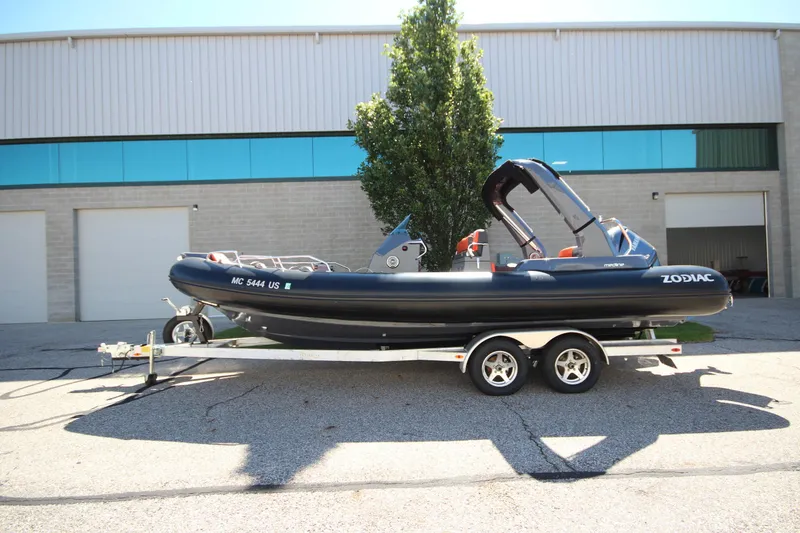 Slide: The Image of 2021 Zodiac Medline 7.5 boat on trailer, parked outside industrial building. - 26