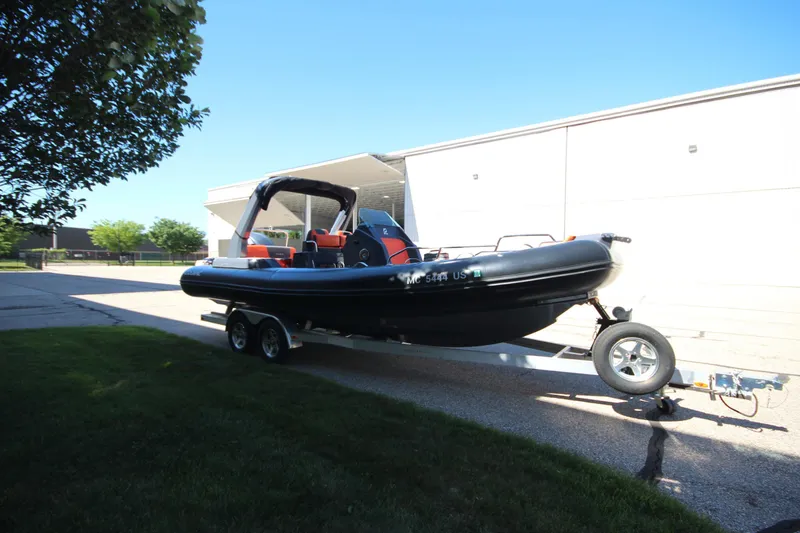 Slide: The Image of 2021 Zodiac Medline 7.5 boat on trailer, parked outdoors near a building. - 4