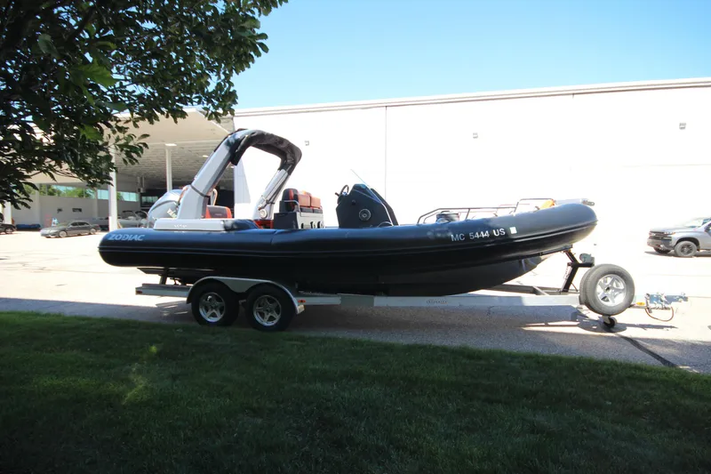 Slide: The Image of 2021 Zodiac Medline 7.5 boat on trailer, parked outdoors in a sunny setting. - 5