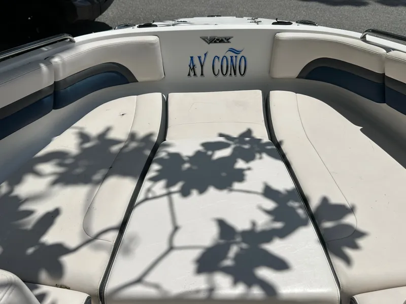 Slide: The Image of The image shows the bow area of a 2017 Chaparral 243VRX boat with white upholstery. - 10