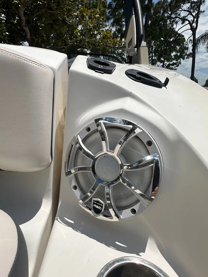 Slide: The Image of Speaker and control console on a Chaparral 243VRX boat, surrounded by trees. - 11