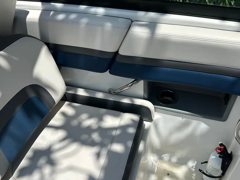 Slide: The Image of Interior of a 2017 Chaparral 243VRX with white and blue seating. - 13