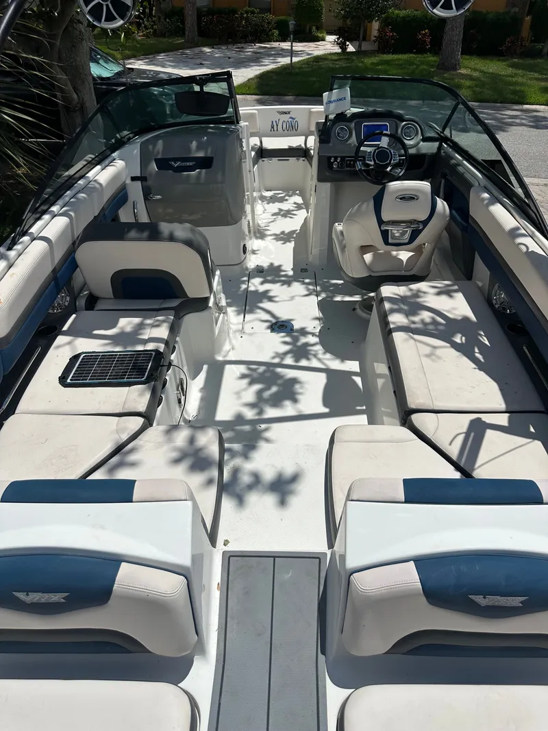 Slide: The Image of Interior view of a 2017 Chaparral 243VRX with white and blue seating and a modern dashboard. - 14