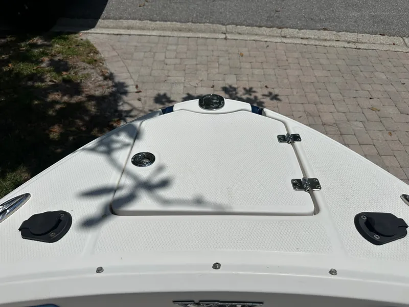 Slide: The Image of The bow of a 2017 Chaparral 243VRX boat on a paved path. - 15