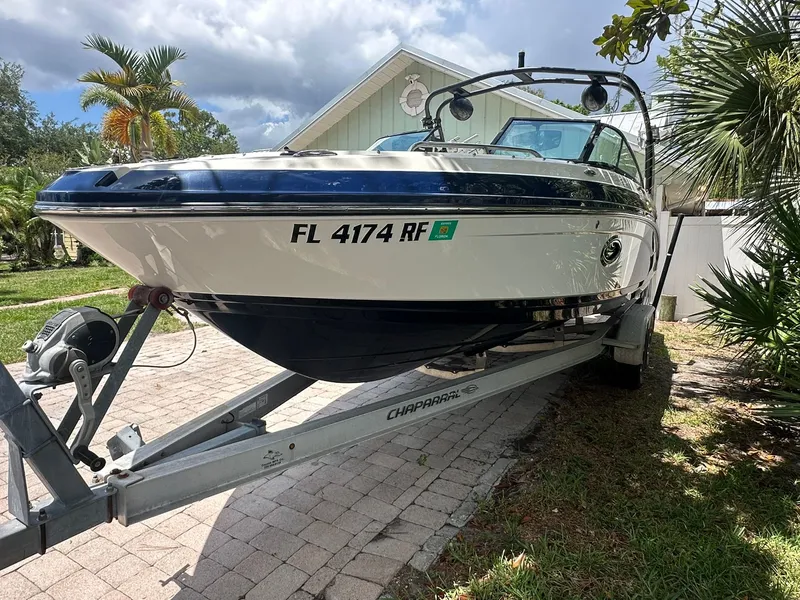 Slide: The Image of 2017 Chaparral 243VRX on a trailer in a garden setting. - 2