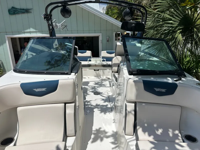 Slide: The Image of 2017 Chaparral 243VRX with white and blue interior, parked in front of a house. - 22