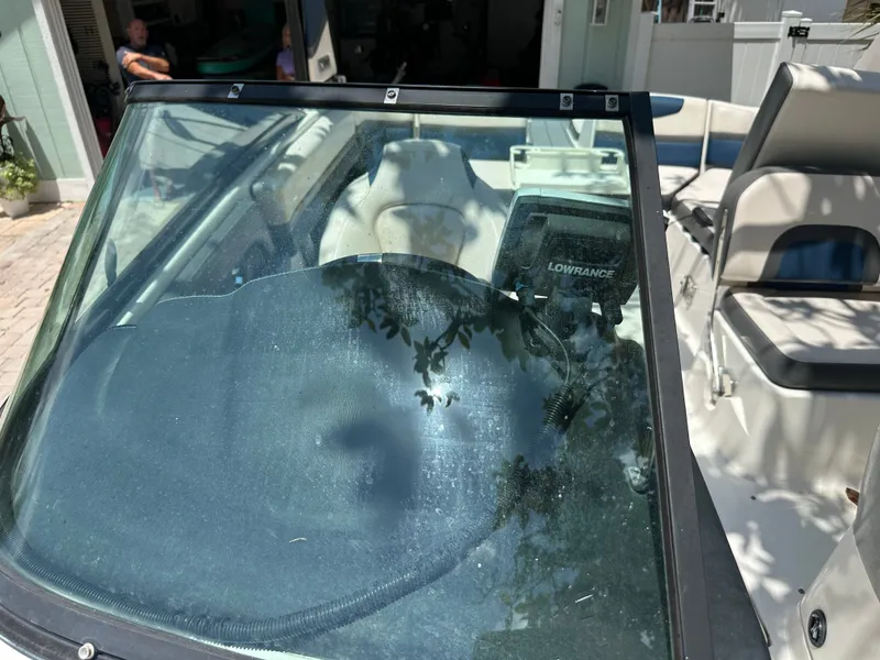 Slide: The Image of Chaparral 243VRX 2017 with windshield and helm console, parked in a driveway. - 24