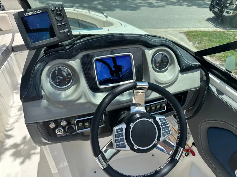Slide: The Image of The image shows the cockpit of a 2017 Chaparral 243VRX with modern instruments. - 29
