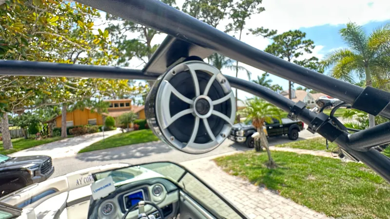 Slide: The Image of Speaker on a Chaparral 243VRX boat, surrounded by trees and cars. - 37