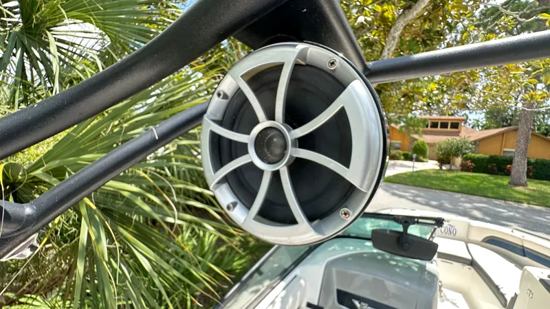 Slide: The Image of Speaker on a 2017 Chaparral 243VRX boat, surrounded by palm trees. - 38