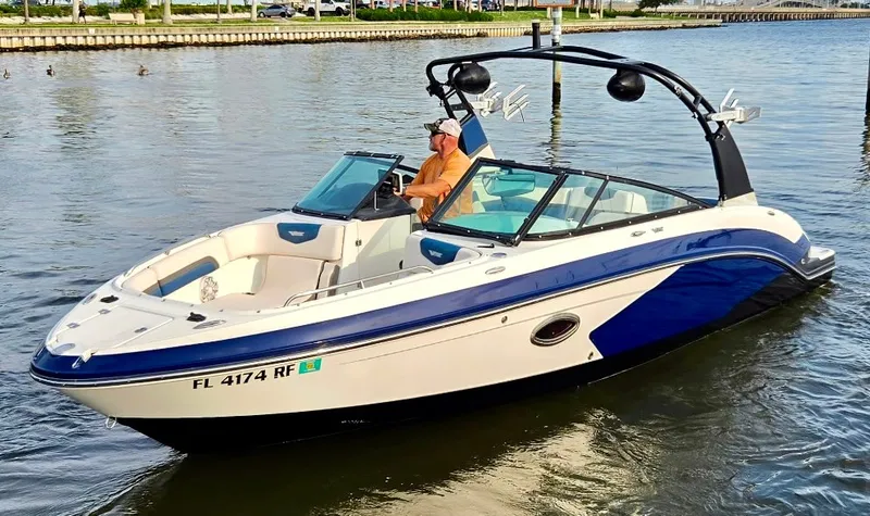 The Image of A 2017 Chaparral 243VRX cruising on calm waters. A man is steering the boat. - 0