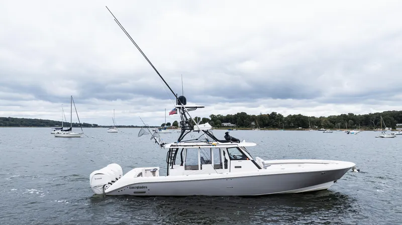 Slide: The Image of 2017 Everglades 435 CC boat on a calm lake with cloudy skies. - 10