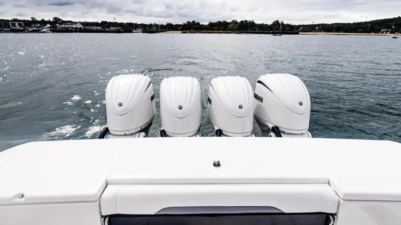 Slide: The Image of Four powerful outboard engines on a 2017 Everglades 435 CC boat, cruising on calm waters. - 15