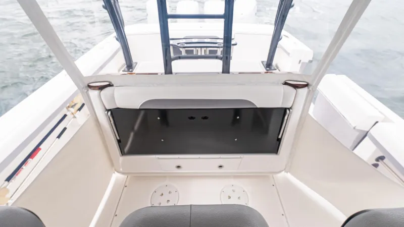 Slide: The Image of 2017 Everglades 435 CC boat interior with seating and storage. - 24
