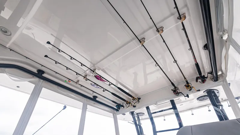 Slide: The Image of Fishing rods stored on a 2017 Everglades 435 CC boat ceiling rack. - 48