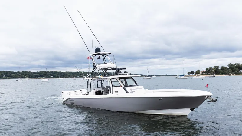 Slide: The Image of 2017 Everglades 435 CC boat on calm water with cloudy sky background. - 5