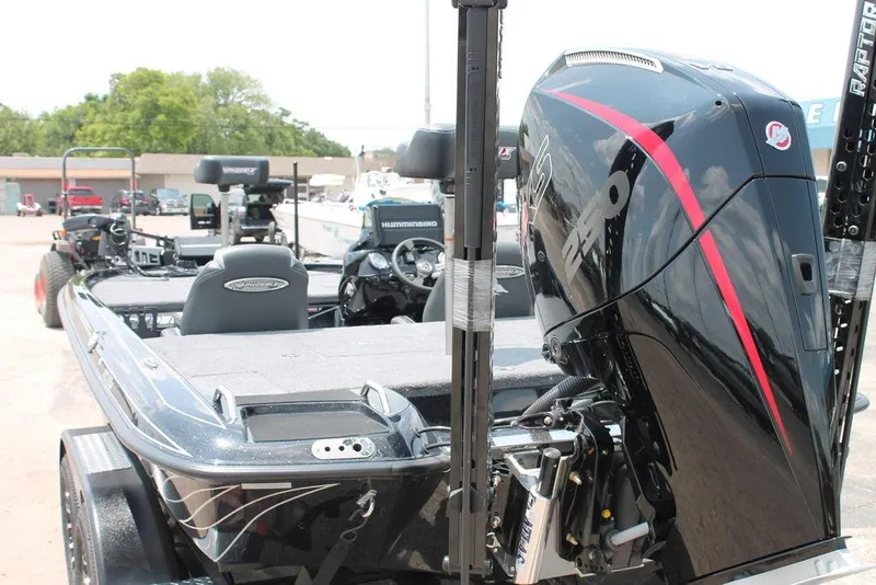 Slide: The Image of 2025 Phoenix 920 Elite boat with powerful outboard motor, parked outdoors. - 7