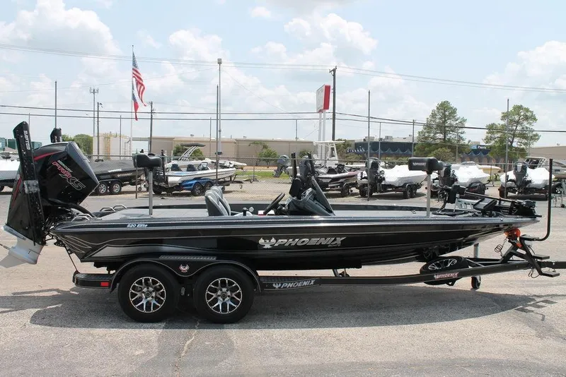 Slide: The Image of 2025 Phoenix 920 Elite boat on trailer in dealership lot, side view. - 3