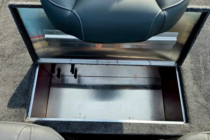 Slide: The Image of 2026 Tracker Bass Tracker Classic XL boat storage compartment with open lid and cushioned seat. - 20