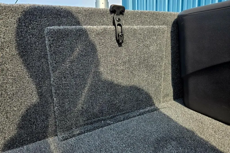 Slide: The Image of 2026 Tracker Bass Tracker Classic XL interior with carpeted surface and latch detail. - 30