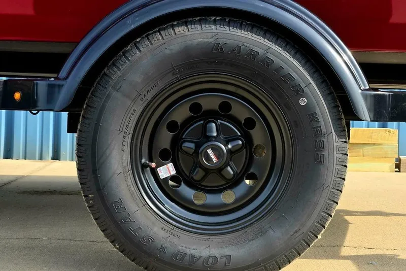 Slide: The Image of 2026 Tracker Bass Tracker Classic XL trailer tire with black rim and Karrier KR35 branding. - 24