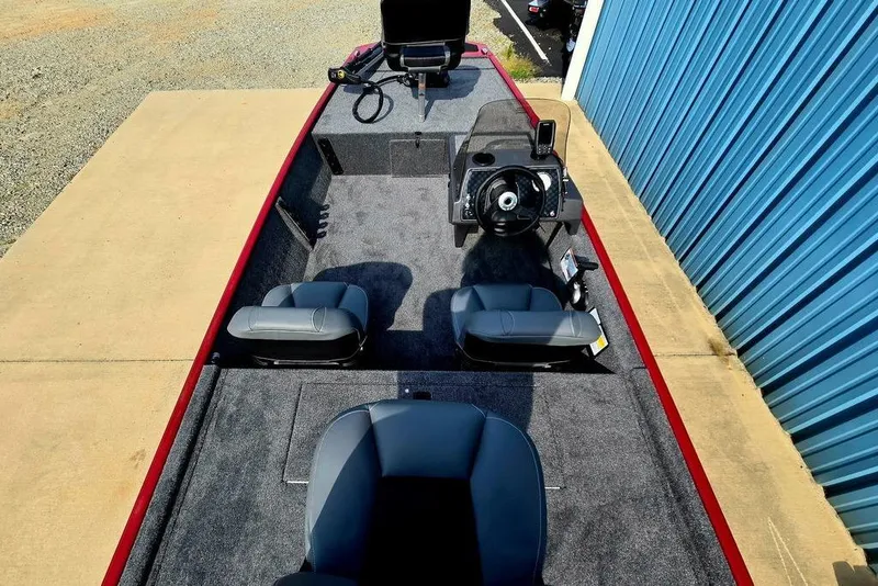 Slide: The Image of 2026 Tracker Bass Tracker Classic XL boat interior with steering console and seating. - 17