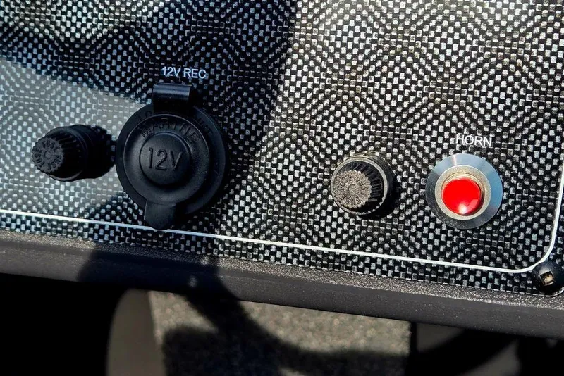 Slide: The Image of Dashboard controls of 2026 Tracker Bass Tracker Classic XL with 12V socket and horn button. - 15