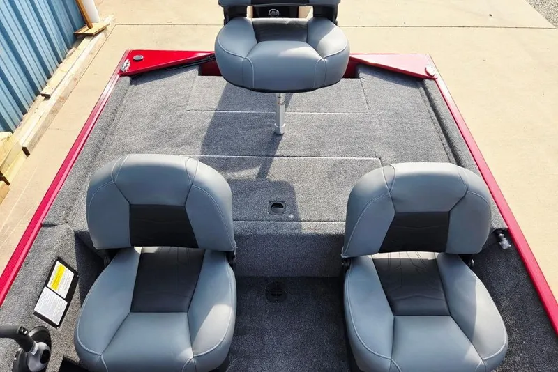 Slide: The Image of 2026 Tracker Bass Tracker Classic XL boat interior with three gray seats and red trim. - 14
