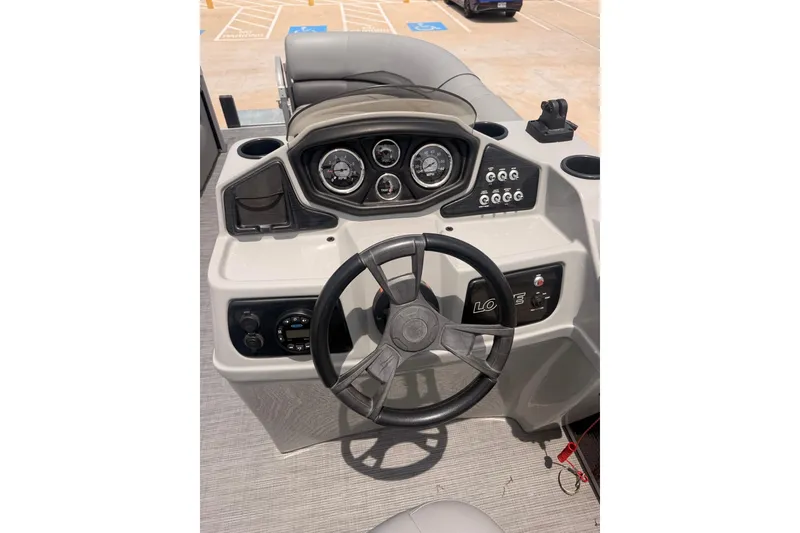 Slide: The Image of Steering console of a 2021 Lowe SS 210 boat with gauges and controls. - 11