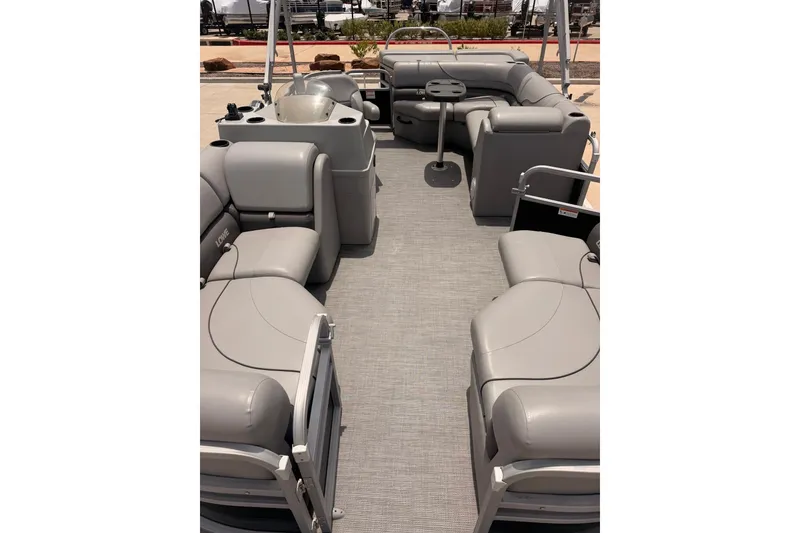 Slide: The Image of 2021 Lowe SS 210 pontoon boat interior with gray seating and spacious layout. - 13