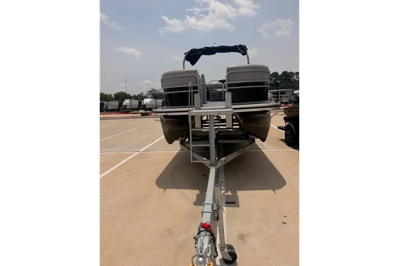 Slide: The Image of 2021 Lowe SS 210 pontoon boat on trailer in parking lot. - 3