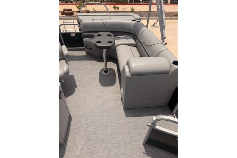 Slide: The Image of 2021 Lowe SS 210 pontoon boat interior with gray seating and table. - 6