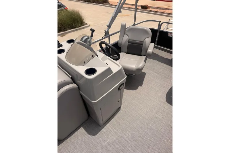Slide: The Image of 2021 Lowe SS 210 boat interior with steering console and captain's chair. - 7