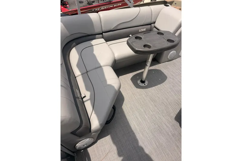 Slide: The Image of 2021 Lowe SS 210 boat interior with gray seating and a small table. - 9