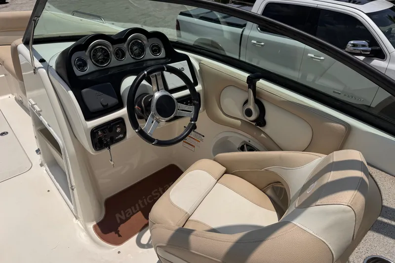 Slide: The Image of 2018 NauticStar 243DC Sport Deck boat interior with steering wheel and dashboard controls. - 11