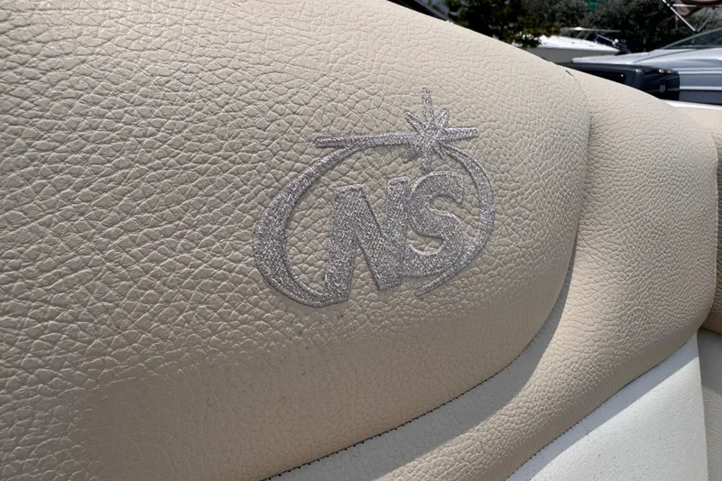 Slide: The Image of Close-up of NauticStar 243DC Sport Deck 2018 boat seat with embroidered logo. - 14