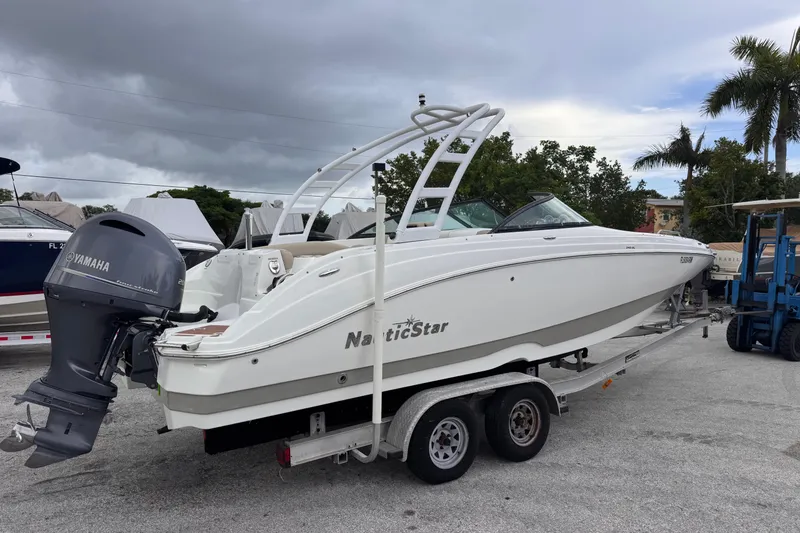 Slide: The Image of 2018 NauticStar 243DC Sport Deck boat on trailer with Yamaha outboard motor. - 3