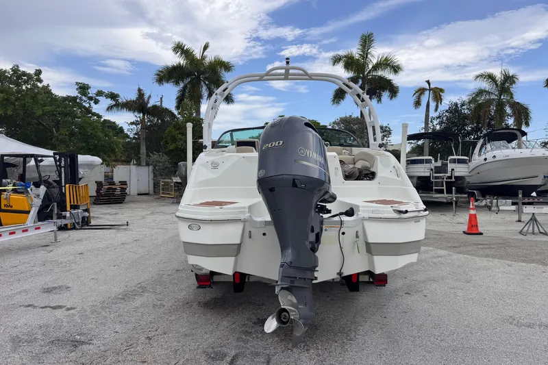 Slide: The Image of 2018 NauticStar 243DC Sport Deck boat with Yamaha engine, parked outdoors. - 4
