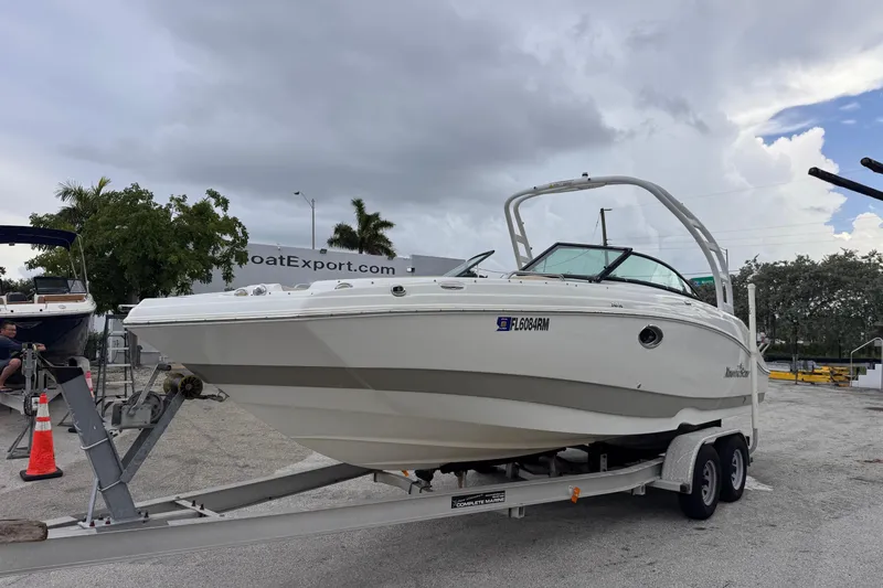 Slide: The Image of 2018 NauticStar 243DC Sport Deck boat on trailer, cloudy sky background. - 6