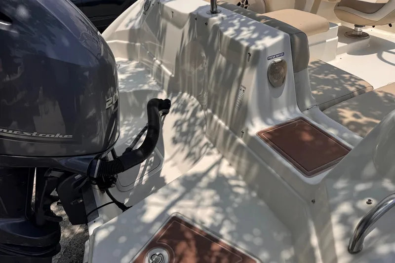 Slide: The Image of 2018 NauticStar 243DC Sport Deck boat with outboard motor and seating area. - 7