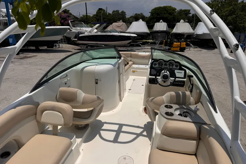 Slide: The Image of 2018 NauticStar 243DC Sport Deck boat interior with seating and dashboard. - 9