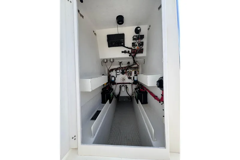 Slide: The Image of Interior view of a 2022 Rambo 27 model boat's engine compartment, showcasing wiring and components. - 10