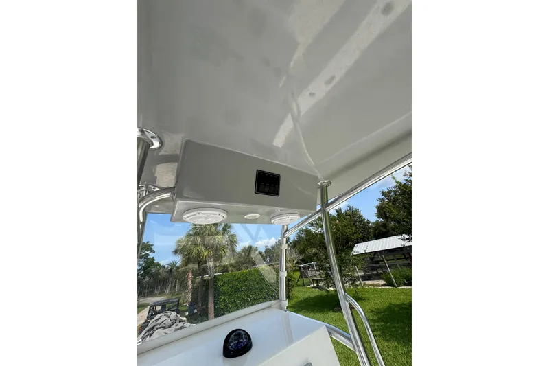 Slide: The Image of Rambo 27 boat interior, 2022 model, featuring a sleek overhead console and outdoor view. - 2